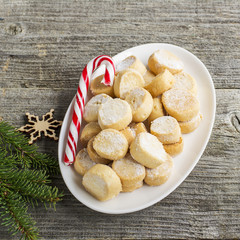Domestic oil small round cookies in the form of coins on the feast  sweet cane and fir branches. Top view