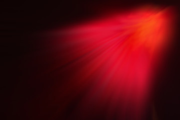 The red rays of light on a dark background