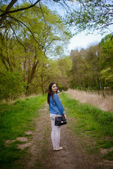 Fototapeta premium Young girl on a walk in the forest