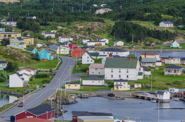 Fototapeta na wymiar Small village community, Twillingate, Newfoundland. Homes along shoreline in this coastal village, local roads connect the community along the Island's edges.