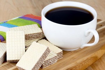 wafer cookies with a cup of  black coffee