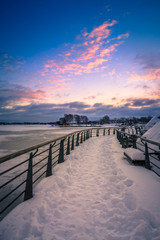 Fototapeta na wymiar View of a frozen lake during sunrise in winter season. Location: Ramsey Lake, Ontario, Canada