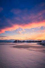 Obraz premium View of a frozen lake during sunrise in winter season. Location: Ramsey Lake, Ontario, Canada