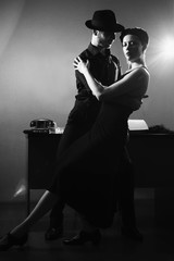 Film noir: romantic loving couple embracing in the dark, 1950s style