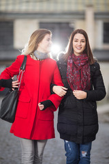 Happy young friends walking together outdoors