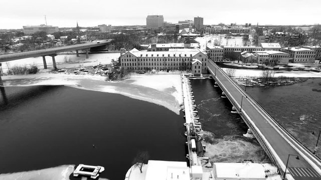 Classic black and white aerial view of Appleton Wisconsin Fox River waterfront area in winter snow, aerial view.