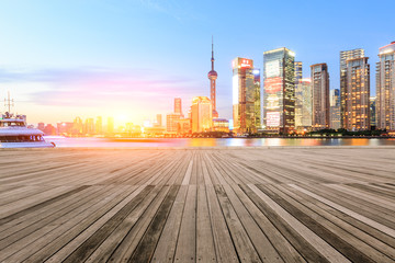Empty floor with modern skyline and buildings at sunset in Shanghai