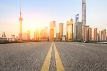 Fototapeten Asphalt road and modern cityscape at sunset in Shanghai © ABCDstock