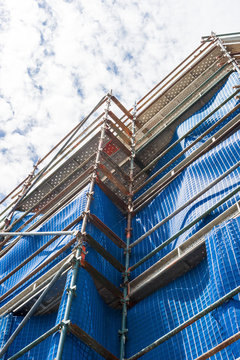 Modern Apartment Construction Site Scaffolding Tarpaulin Covering Copyspace.