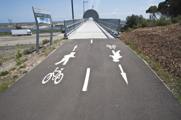Safe way across busy road. Pedestrian bicycle bridge over very busy road.