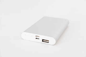 Portable power bank for charging mobile devices, on white background