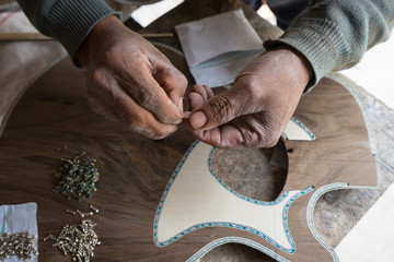 hands of a luthier man in Ecuador 