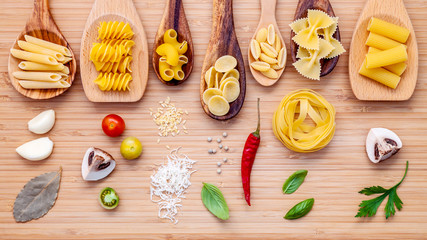Italian cuisine concept .Various kind of pasta in wooden spoons