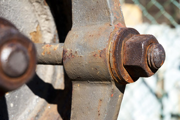 Shallow depth of field rusty metal fittings showing bolts one focus one out of focus.