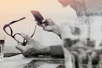 Double exposure of businessman hand using mobile payments online