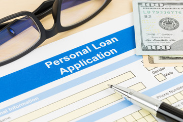 Personal loan application form with glasses dollar money, and pe