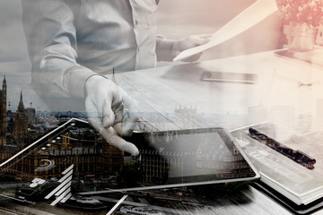 Double exposure of businessman working with digital tablet compu