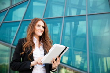 Fototapeta premium business woman checking data on her tablet computer outdoor