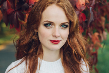 Portrait of happy beautiful redhaired girl smiling