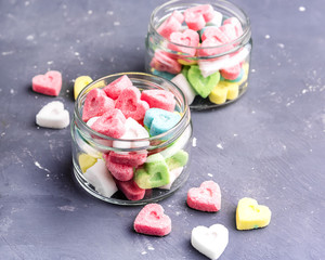Jars with colored sugar in shape of heart