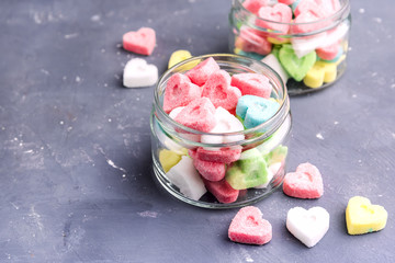 Jars with colored sugar in shape of heart