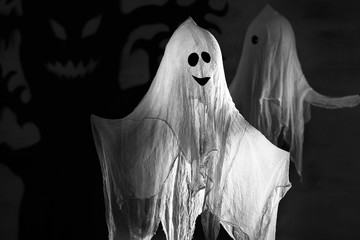 Funny ghost as decor for Halloween party, on dark background