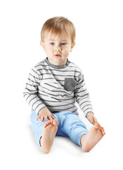 Cute little boy sitting on white background