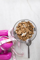cereals or muesli with tape measure and weight, diet and exercise concept