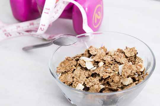 cereals or muesli with tape measure and weight, diet and exercise concept