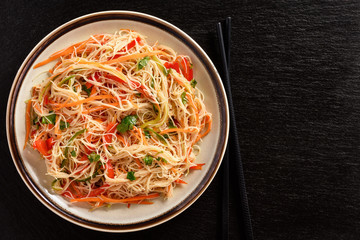 Asian salad with rice noodles and vegetables.