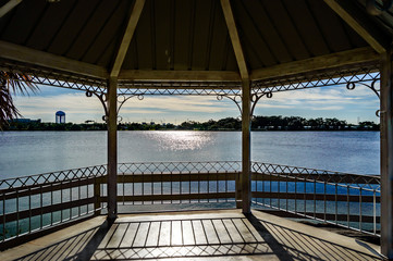 Fototapeta na wymiar Gazebo lake view / a photo of the inside of a gazebo in the tropical state of Florida Hollywood by the lake in TY park.