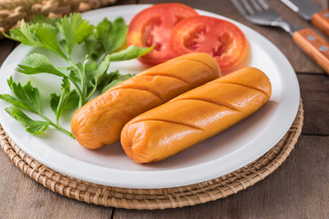 Grilled sausage with vegetables on plate