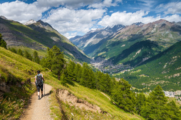 Fototapeta na wymiar Girl walking on spectacular mountain scenery, Alps, Switzerland.