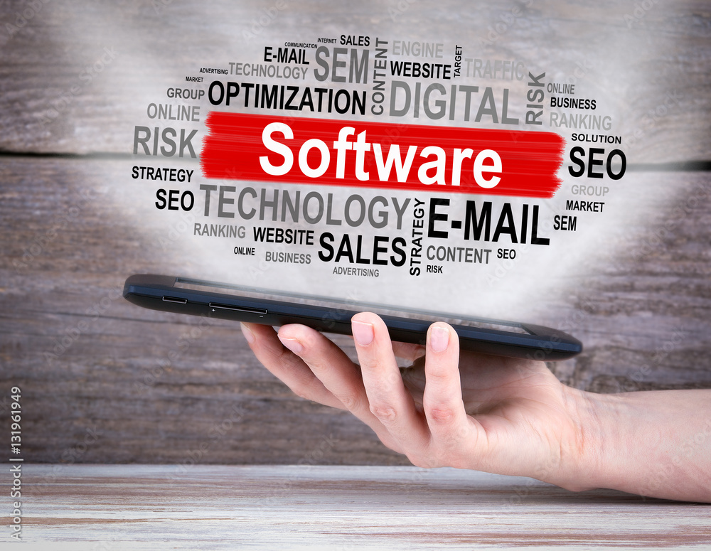 Poster software concept. tablet computer in the hand. old wooden background.