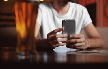 Man using cellphone in cafe