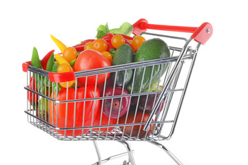 Fresh vegetables in shopping cart on white background