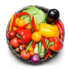 Group of fresh vegetables in basket on white background