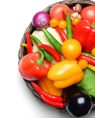 Group of fresh vegetables in basket on white background