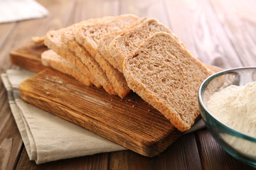 Sliced bread on wooden cutting board closeup