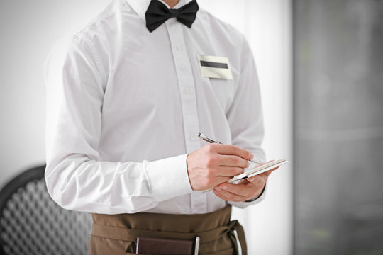 Cute waiter taking an order, close up