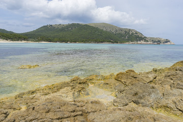 Fototapeta na wymiar Holiday, Rocks by the sea with waves of the Mediterranean sea ne