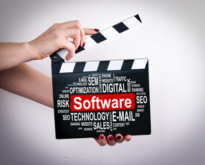Software concept. Female hands holding movie clapper. 