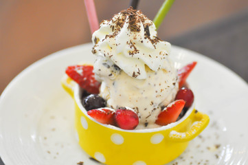 ice cream with whipped cream and berry