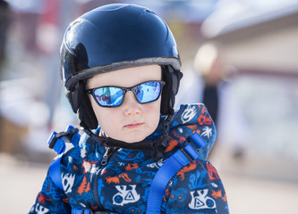 Toddler Dressed Safely for Skiing with Helmet, Harness & Sunglasses at a Colorado Ski Resort