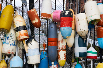 Old colourful buoys fixed on a fishing net