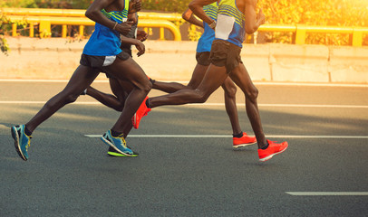 marathon runners running on city road