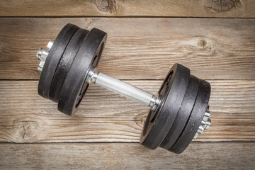 cast iron dumbbell on wood