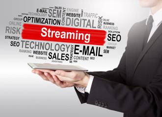 Streaming concept, young man holding a tablet computer