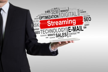 Streaming concept. Man holding a tablet computer