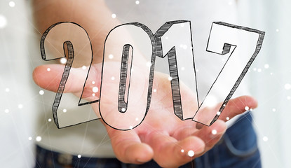Businessman holding 2017 hand drawn text